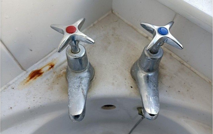 Bathroom taps and basin before Bright Path cleaning